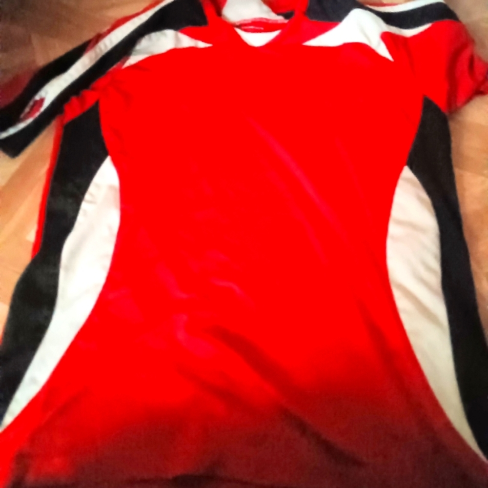 A red white and black short sleeve soccer shirt